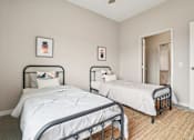 Thumbnail 11 of 42 - Two twin beds in a room with white bedspreads and pillows.