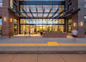 Thumbnail 21 of 21 - the entrance of a building with people walking in front of it