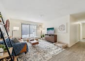Thumbnail 7 of 31 - Living Area with TV at The Bosk Apartment Homes, Minnesota, 55125