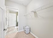 Thumbnail 20 of 45 - A white room with a white shelf and a white box on the floor.