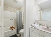 Thumbnail 14 of 31 - White Bathtub in Bathroom at The Bosk Apartment Homes, Woodbury, MN
