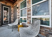 Thumbnail 12 of 42 - Two grey chairs are placed on a patio.