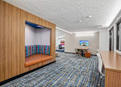 Thumbnail 32 of 46 - A room with a blue carpet and wooden walls.