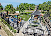 Thumbnail 39 of 46 - A playground with a black fence and a gazebo.