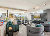 Thumbnail 32 of 40 - A modern living room with grey and green furniture.