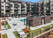 Thumbnail 15 of 42 - Large courtyard with a pool surrounded by apartment buildings at Arcata Apartments, Golden Valley, Minnesota