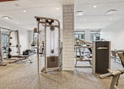 Thumbnail 24 of 42 - Gym with a variety of equipment including a treadmill, weights, and bench press at Arcata Apartments, Minnesota, 55416