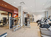 Thumbnail 25 of 42 - Gym with a variety of equipment including treadmills at Arcata Apartments, Golden Valley, MN