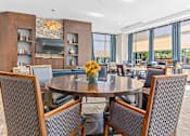 Thumbnail 26 of 33 - a dining room with tables and chairs and a large window