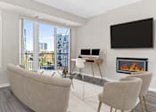 Thumbnail 5 of 33 - a living room with a couch and a desk and a fireplace