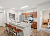 Thumbnail 1 of 54 - A kitchen with a marble countertop and wooden cabinets.