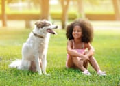 Thumbnail 12 of 31 - a girl sitting on the grass with her dog