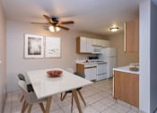 Thumbnail 8 of 24 - Kitchen with White Cabinets and Open Dining Room with Table