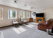 Thumbnail 19 of 24 - a living room with a couch and chair and a fireplace