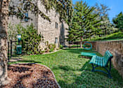 Thumbnail 15 of 24 - our apartments have a small yard with a bench and a tree