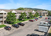 Thumbnail 17 of 24 - an aerial view of an apartment complex with cars parked in a parking lot