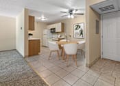 Thumbnail 1 of 24 - a dining room with a table and chairs and a kitchen
