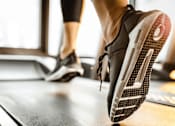 Thumbnail 12 of 24 - a woman running on a treadmill in the gym