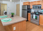 Thumbnail 2 of 11 - Kitchen with Stove Fridge and Island