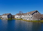Thumbnail 1 of 24 - Exterior image of Avalon Cove Townhomes looking out onto the water of the cove.
