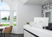 Thumbnail 10 of 24 - a living room with a view of a lake and a table and chairs
