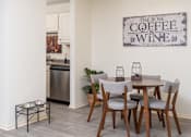 Thumbnail 13 of 28 - a dining room with a table and chairs and a sign that reads coffee and wine at The Bosk Apartment Homes, Minnesota