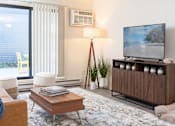 Thumbnail 10 of 28 - a living room with a couch and a coffee table at The Bosk Apartment Homes, Woodbury