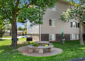 Thumbnail 19 of 22 - a stone picnic table in the yard of an apartment building