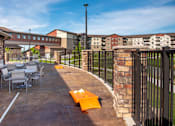 Thumbnail 8 of 24 - Outdoor Patio with Tables and Cornhole