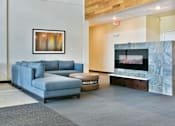 Thumbnail 12 of 24 - Lobby Lounge with Couch and Fireplace