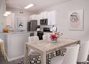 Thumbnail 6 of 27 - Modern and spacious dining area looking into open kitchen.