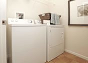 Thumbnail 14 of 27 - a washer and dryer in a laundry room