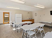 Thumbnail 10 of 13 - a dining room with tables and chairs and a television