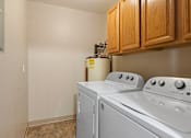 Thumbnail 7 of 13 - the laundry room has a washer and dryer and wood cabinets