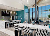 Thumbnail 9 of 24 - Sky lounge kitchen area, with full kitchen and bar, high seating, and fireplace connected to the ceiling