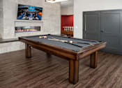 Thumbnail 17 of 30 - Pool table in community space across from fireplace and mounted TV.
