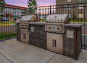 Thumbnail 25 of 30 - Community grills in a fenced in community space.