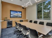 Thumbnail 14 of 28 - a conference room with a large window and a table and chairs