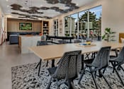 Thumbnail 2 of 28 - a dining room with a table and chairs