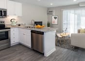 Thumbnail 3 of 30 - A modern kitchen with a dining area.