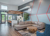 Thumbnail 16 of 30 - A modern living room with a grey sofa and a wooden coffee table.