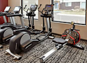 Thumbnail 20 of 30 - a group of exercise machines in a gym