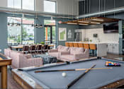 Thumbnail 15 of 30 - a common room with a pool table and a bar