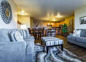 Thumbnail 5 of 10 - a living room and dining room with couches and a table