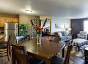 Thumbnail 1 of 10 - the view of a living room and dining room with a table and chairs
