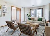 Thumbnail 3 of 18 - a living room with a couch and a table and two chairs