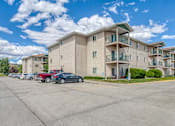 Thumbnail 18 of 18 - a row of apartment buildings with cars parked in front of them