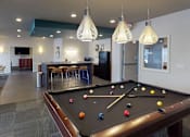 Thumbnail 14 of 21 - a game room with a pool table and a bar