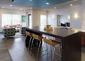 Thumbnail 13 of 21 - a kitchen with a counter top and bar stools