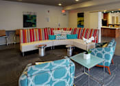 Thumbnail 16 of 21 - a living room with couches and chairs and a table